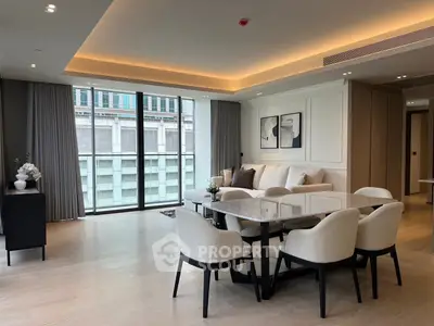 Luxurious modern living room with elegant dining area and large windows offering city views.