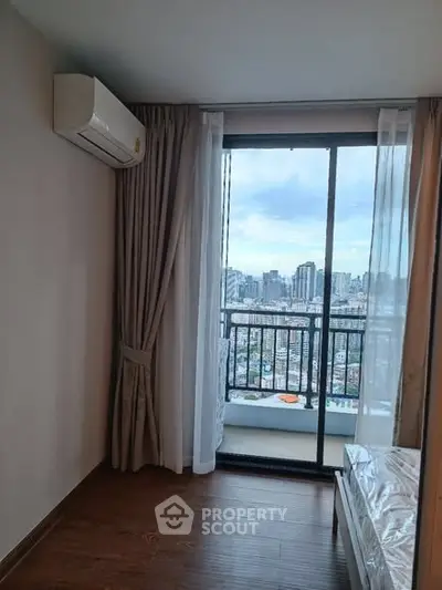 Cozy bedroom with city view balcony and air conditioning