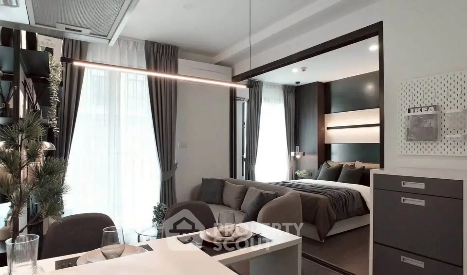 Modern open-plan living and bedroom area with stylish decor and natural light.