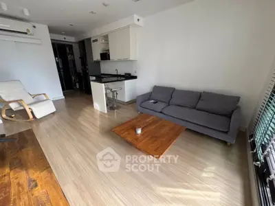 Modern living room with open kitchen and stylish furniture