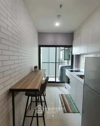 Modern kitchen with sleek cabinetry and breakfast bar in a stylish apartment
