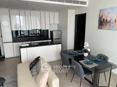 Modern open-layout kitchen and dining area with sleek design and elegant decor