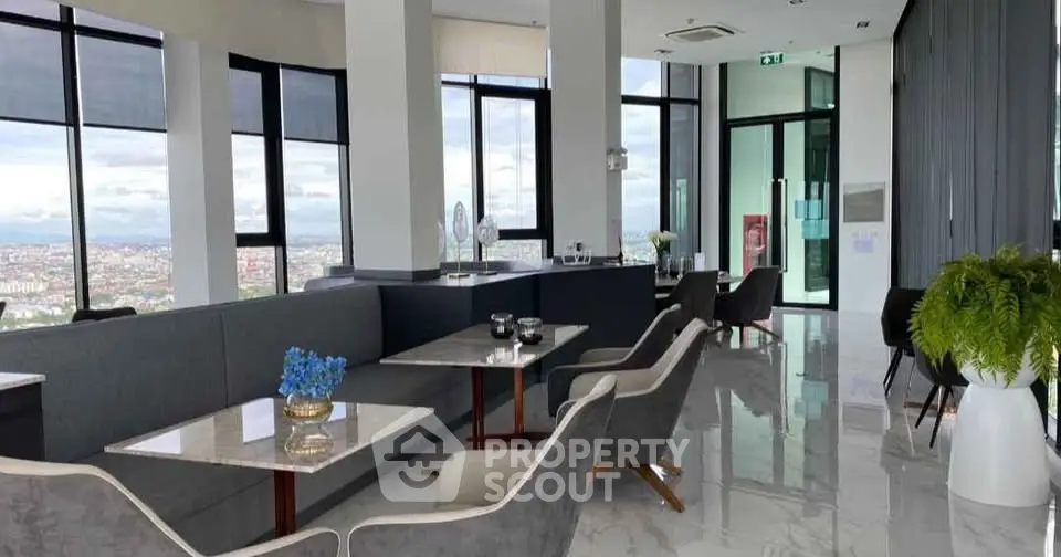 Luxurious high-rise living room with panoramic city views and modern decor.