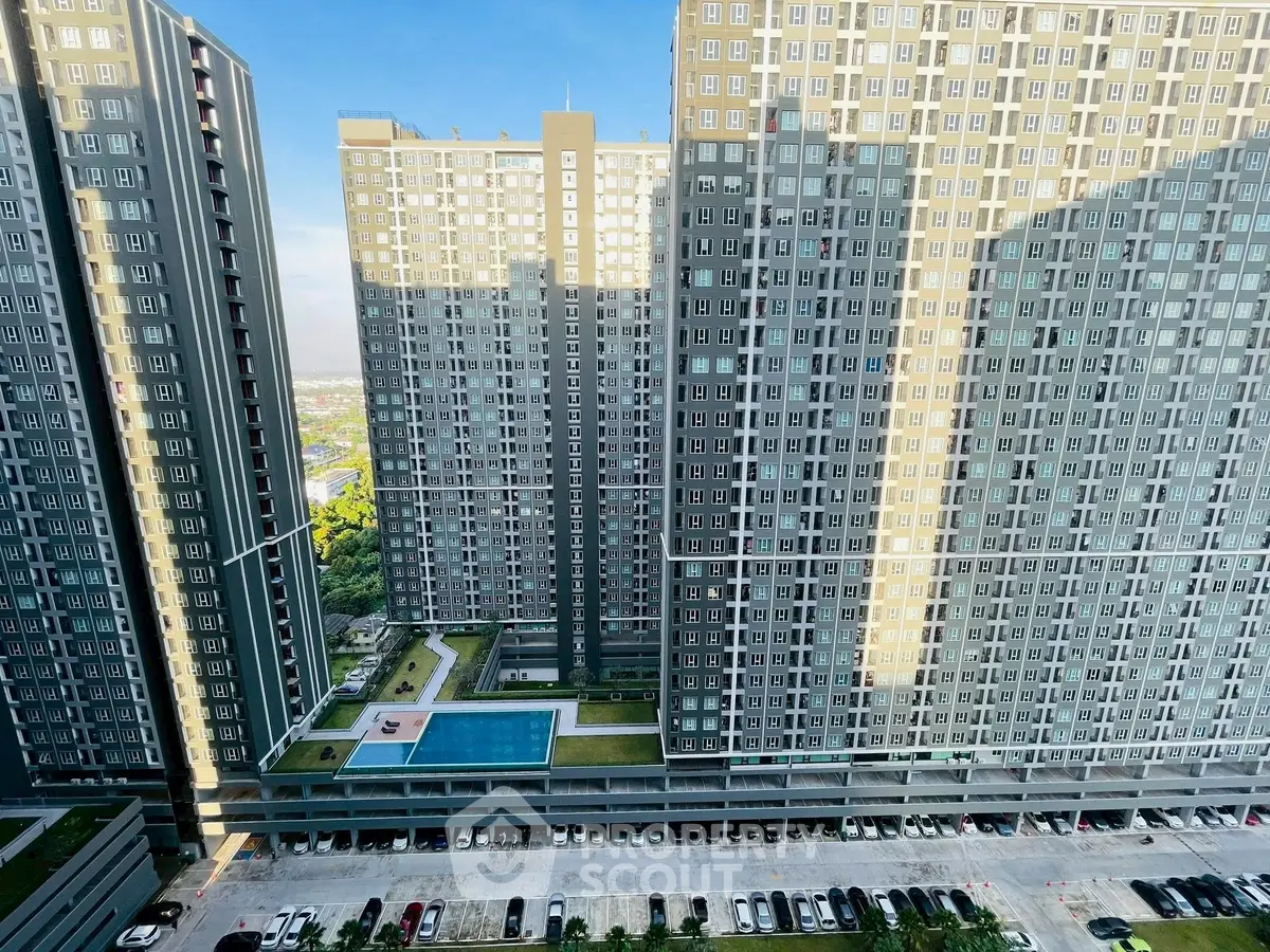 Stunning high-rise apartment complex with pool and parking view