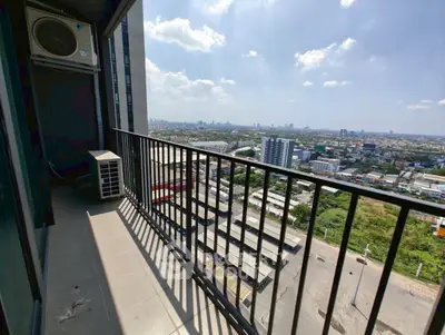 Spacious balcony with stunning cityscape view in modern high-rise apartment