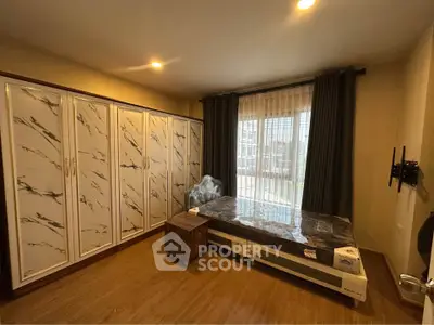 Spacious bedroom with large wardrobe and modern decor