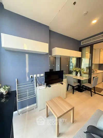 Modern living room with stylish furniture and dining area in a contemporary apartment.