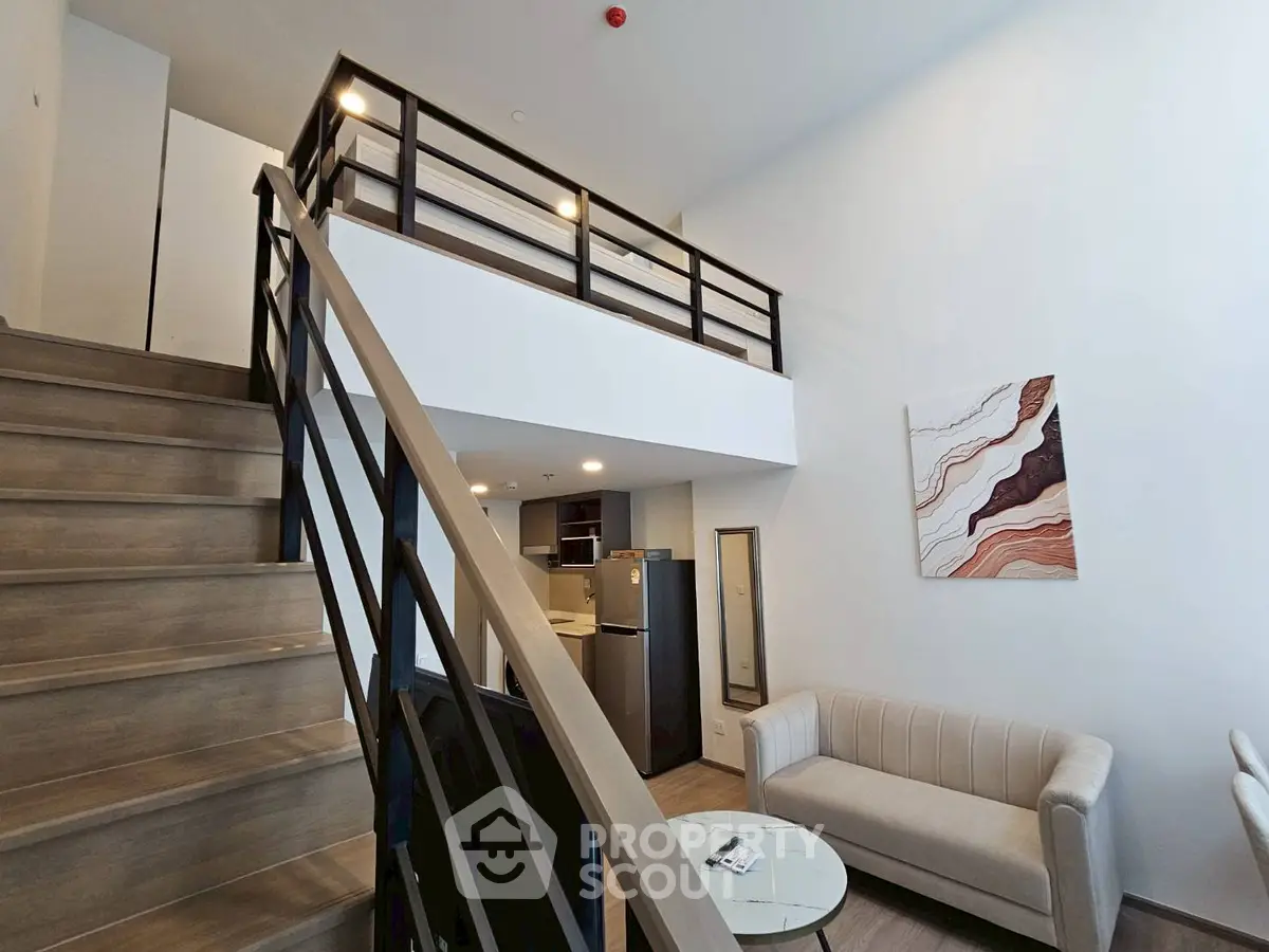 Modern loft apartment with stylish staircase and cozy living area