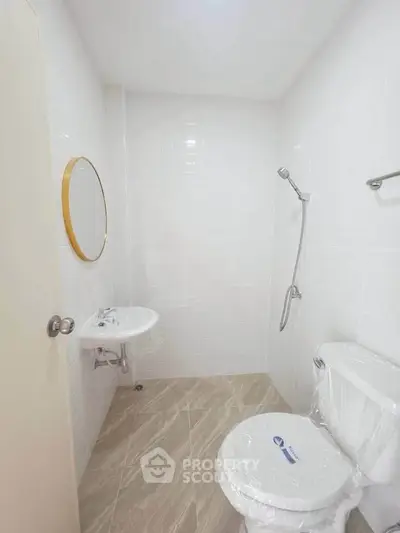 Modern minimalist bathroom with white tiles and sleek fixtures