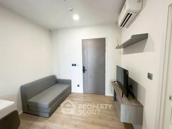 Modern living room with sleek furniture and air conditioning in a cozy apartment.