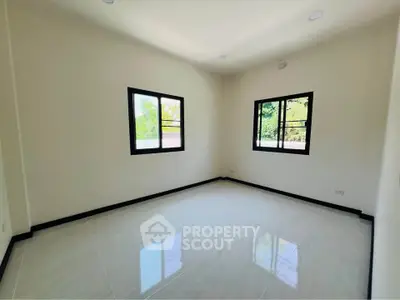 Spacious empty room with large windows and natural light, perfect for customization.