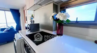 Modern kitchen with sleek countertop and appliances, featuring a scenic window view.