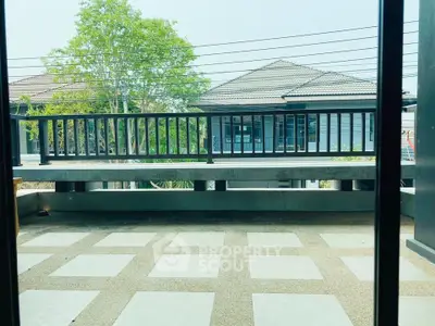 Spacious balcony with modern railing and scenic view of suburban homes.