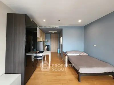 Modern studio apartment with wooden flooring and minimalist decor