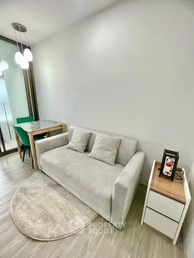 Modern living room with cozy sofa and dining area in a stylish apartment.