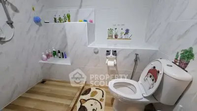 Charming bathroom with unique decor and modern fixtures, featuring a cozy shower area and playful accents.