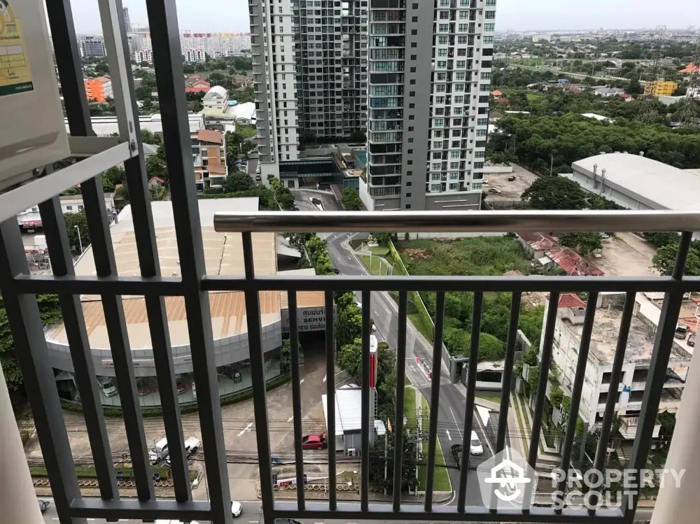 High-rise balcony with stunning cityscape view and modern urban surroundings.