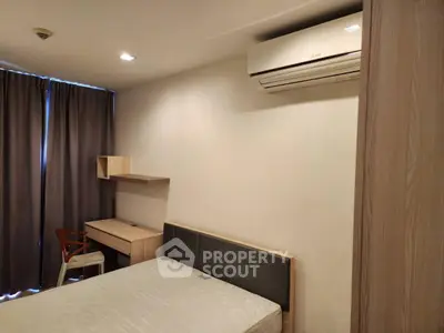 Cozy bedroom with modern furniture and air conditioning, perfect for comfortable living.