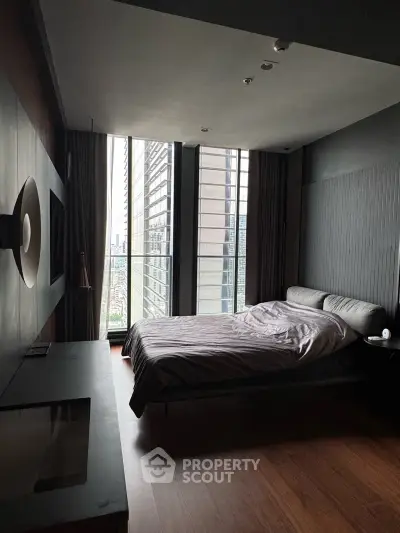Luxurious modern bedroom with floor-to-ceiling windows and stunning city view