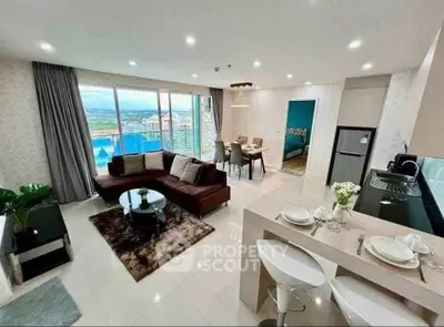 Luxurious open-plan living room with stunning city view and modern kitchen