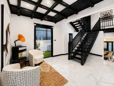 Elegant modern living space with stylish staircase and cozy seating area.