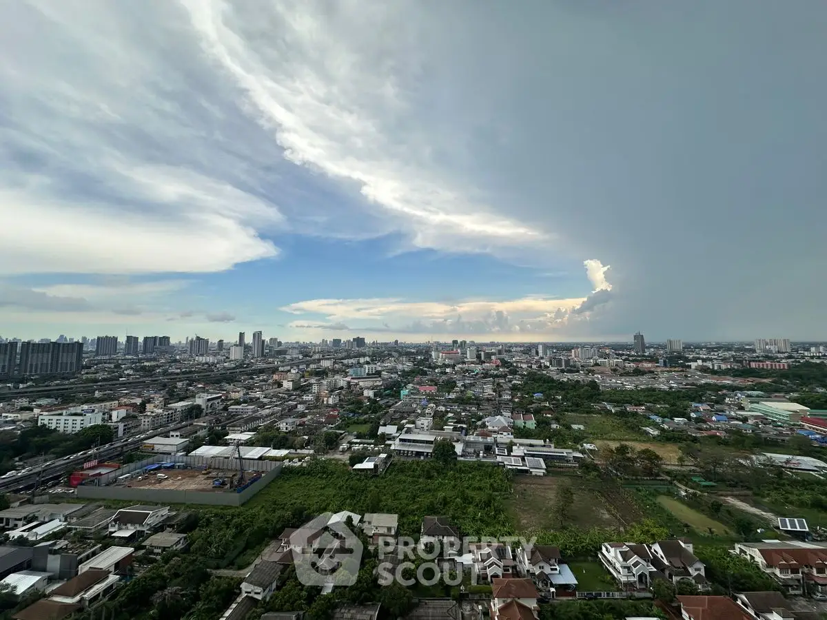 Stunning panoramic cityscape view from high-rise apartment showcasing urban skyline and lush greenery.