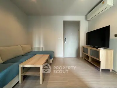 Modern living room with sleek furniture and air conditioning, perfect for relaxation.