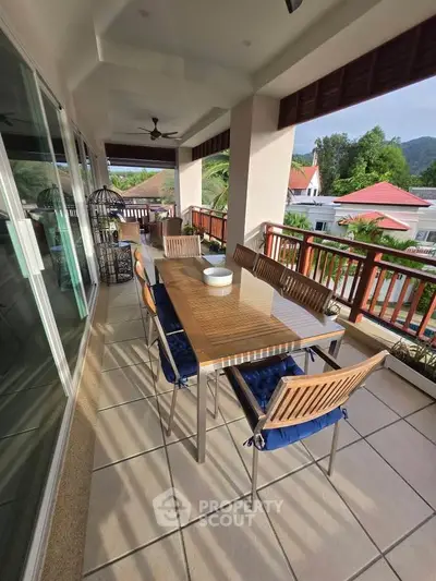 Spacious balcony with dining set and scenic views in a modern home