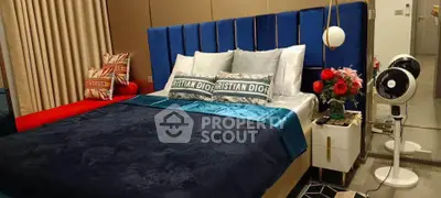 Luxurious bedroom with stylish decor and plush bedding in modern apartment.