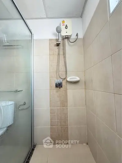 Modern bathroom with shower enclosure and beige tiles