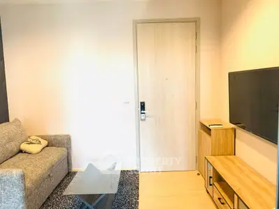 Modern living room with sleek furniture and wall-mounted TV, perfect for cozy relaxation.