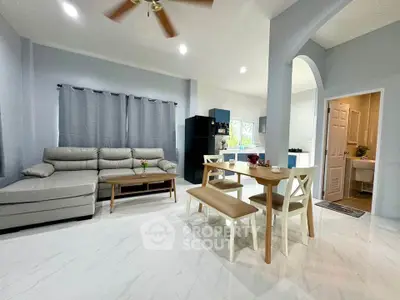 Spacious open-plan living room with modern kitchen and dining area