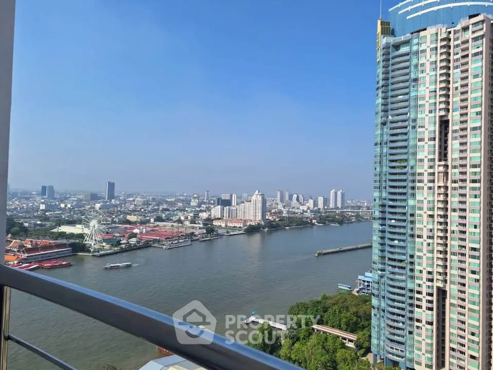 Stunning high-rise river view from a modern balcony in a vibrant cityscape.
