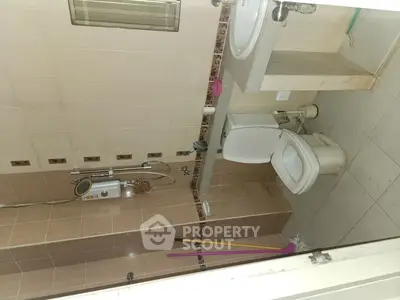 Spacious bathroom with modern fixtures and water heater