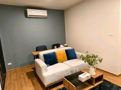 Modern living room with stylish sofa and air conditioning, perfect for cozy relaxation.