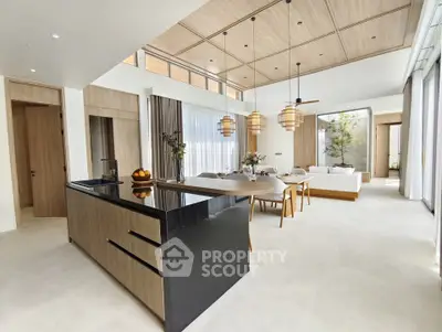 Luxurious open-plan living room with modern kitchen and elegant dining area, featuring high ceilings and natural light.