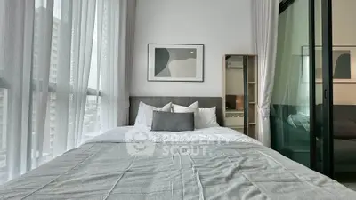 Modern bedroom with large windows and stylish decor in urban apartment