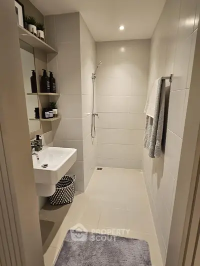 Modern bathroom with sleek design, featuring a walk-in shower and stylish fixtures.