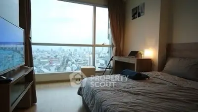 Modern bedroom with city view and cozy decor