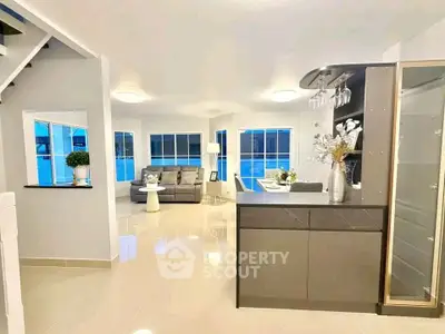 Modern open-plan living room with sleek kitchen and stylish decor