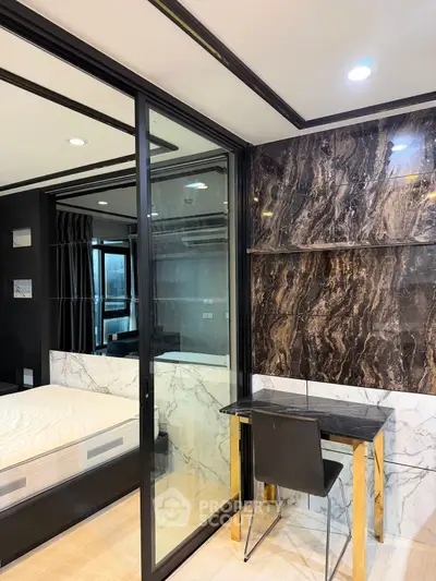 Modern bedroom with glass partition and elegant marble accents