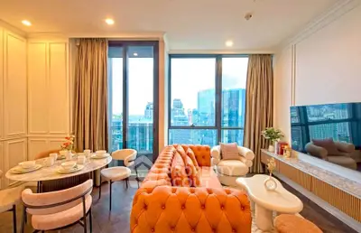 Luxurious living room with stunning city view, elegant furniture, and floor-to-ceiling windows.