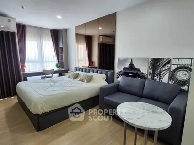 Modern bedroom with stylish decor, featuring a cozy bed, elegant sofa, and chic wall art in a well-lit space.