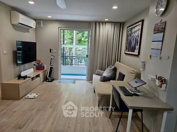 Modern living room with balcony, stylish decor, and natural light in a cozy apartment.