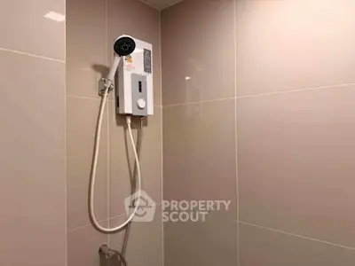 Modern bathroom with sleek shower unit and neutral tiles