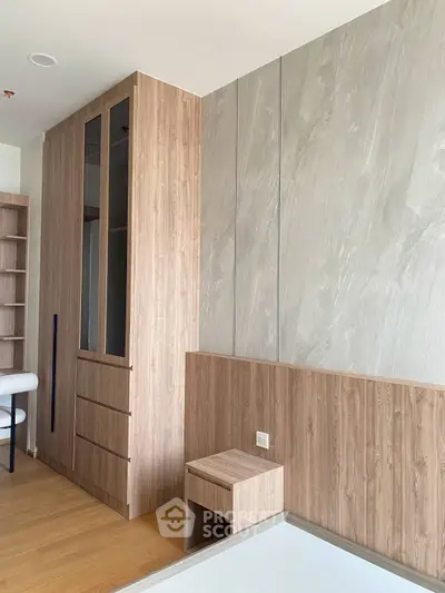 Modern bedroom with sleek wooden cabinetry and neutral tones