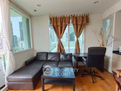Modern living room with city view, featuring a sleek leather sofa and work desk, ideal for urban living.