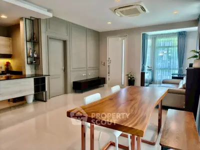 Spacious modern living room with elegant dining area and natural light