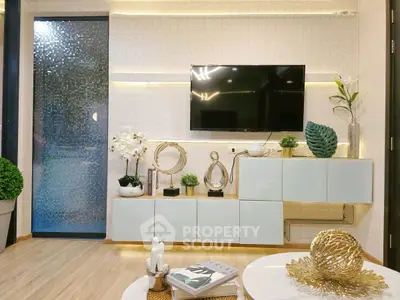 Modern living room with sleek decor, wall-mounted TV, and stylish lighting.