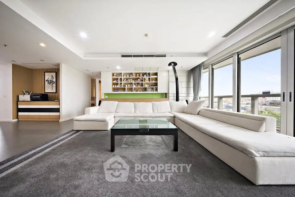 Spacious modern living room with large windows and stylish decor